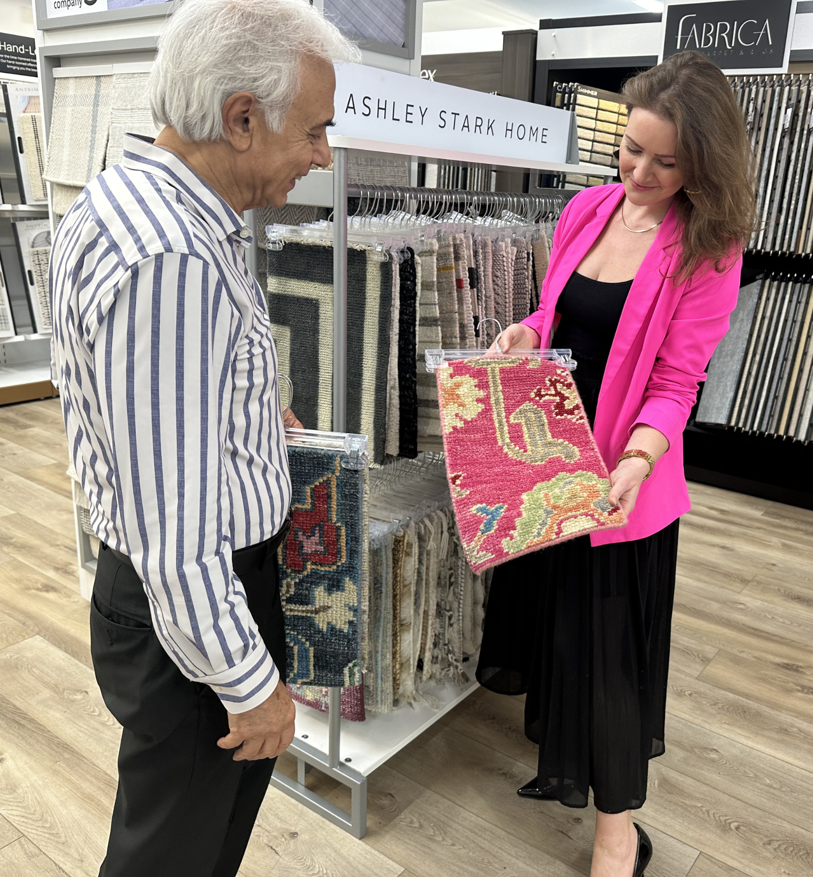 flooring staff in annapolis showroom holding rug